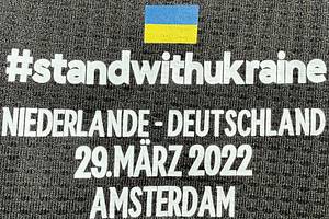  - Original match-issued DFB player shirt with the number 14. Worn by Jamal Musiala in the friendly match against the Netherlands on March 29, 2022, in Amsterdam. The jersey features the special "StandwithUkraine" print to show solidarity with Ukraine. Status:AAB Short-sleeved shirt; size 6; DFB logo, rubberized Adidas logo, match details, rubberized player number and name; rubberized peace patch; Adidas HEAT.RDY; 100% polyester; Made in Cambodia. The jersey comes from a DFB employee. Condition: a - Bild 8
