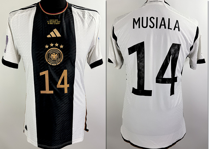  - Original match-issued DFB 2022 World Cup player shirt, number 14, belonging to Jamal Musiala. Prepared for the match against Costa Rica on December 1, 2022, in Qatar. The set consists of the shirt, shorts, and socks. Status: AAB. Short-sleeve shirt; Size 48; Heat-applied DFB logo and Adidas manufacturer logo; heat-applied player number and name; heat-applied 2022 World Cup patch and "Football Unites the World" patch; HEAT.RDY technology; 100% Polyester; Made in Vietnam. Condition: A