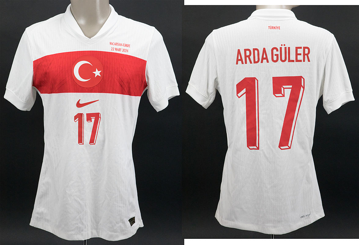 match worn shirt Turkey 2024 Arda Güler - Match worn / issued shirt of Türkiye with number 17 worn by Arda Güler in the friendly match Hungary v Türkiye (1:0) on March 23, 2024. With match print "Macaristan - Türkiye 22 Maart 2024". Güler came on as a substitute in the 61st minute. Status:AAB  --short sleeve; Size "M"; Turkish national coat of arms and Nike logo thickly rubberized; match print; shirt number, name of Güler, thinly gummed. Manufacturer: Nike - Dri-Fit ADV. --The shirt comes from a kit manager from Hungary. This shirt is said to be an exchange shirt that a Hungarian player swapped with Güler. -- shirt slightly stained.  ---Arda Güler (born 2005) is the talent of the year in Turkish football. He won the Spanish double with Real Madrid in 2024. Condition: A-