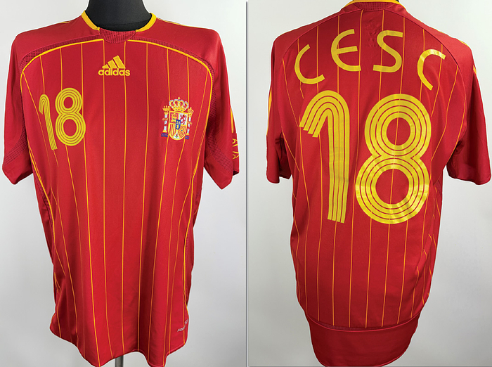  - Original match-worn Spain player shirt, number 18, belonging to Cesc Fàbregas. Worn during one of the four World Cup matches played by Spain in this tournament. Status: AAB. Short-sleeved shirt; Size L; Embroidered national crest; Embroidered Adidas manufacturer logo; Rubberized player number and name; Flocked 2006 World Cup patch; 100% Polyester; Made in China. --The jersey comes from the collection of a DFB official. Condition: A