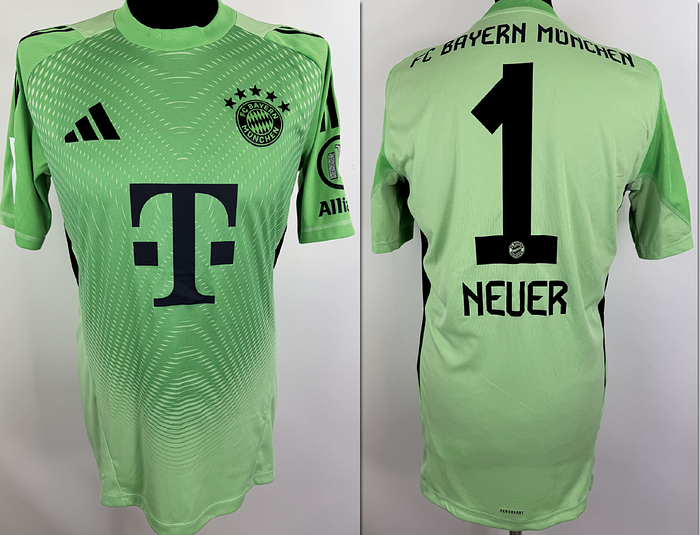  - Original match-worn FC Bayern player shirt, number 1 (Manuel Neuer). Worn in a Bundesliga match during the 2025/2026 season. Status:ABB. Short-sleeved jersey; size L; club crest and Adidas manufacturer logo applied (bonded); sponsor ("T..."), club name, player number, and player name applied (bonded/heat-pressed); back number 25 cm high; Bundesliga patch and Allianz patch applied (bonded/heat-pressed); 100% polyester; made in Vietnam. --Comes from an FC Bayern Munich employee Condition: A
