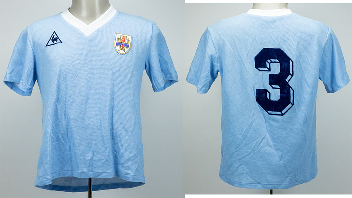  - Original match-worn Uruguay player shirt, number 3. Worn by Eduardo Acevedo during the 1986 World Cup match against Germany on June 4, 1986. This jersey was obtained via a shirt swap with German international and 1990 World Cup champion Rudi Völler. The jersey comes from the personal circle of Rudi Völler’s family. Status: AAA. --Short-sleeved jersey; size M-L; manufacturer "Le Coq Sportif" (flocked); federation emblem (stitched on); number on the back (flocked); 53% cotton, 47% polypropylene; made in France. Condition: A-