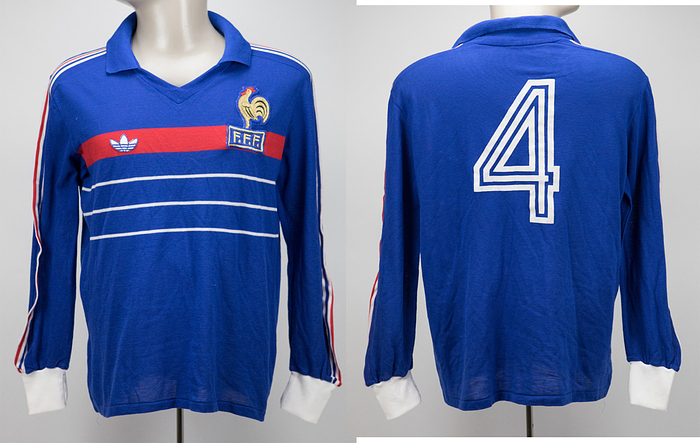  - Original match-worn France playershirt, number 4, belonging to Yvon Le Roux from the match against Germany on April 18, 1984, in Strasbourg. This jersey was obtained via a shirt swap with German international and 1990 World Cup champion Rudi Völler. The jersey comes from the personal collection/circle of Rudi Völler’s family. Status: AAA. --Short-sleeved jersey; size M-L; federation emblem and Adidas manufacturer logo stitched on; player number applied via flocking; 51% polyester, 49% cotton; made in France. Condition: A-