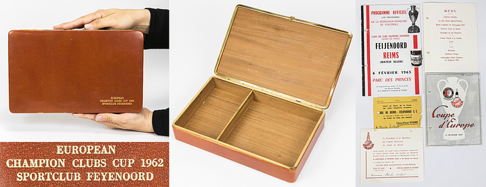  - Large leather-covered cigar box with brass trim; interior lined with tropical wood. Gold-embossed inscription: "European Champion Clubs' Cup 1962 Sportclub Feyenoord." 26 x 16 x 5 cm. A personal item belonging to German FIFA referee Heinz Siebert (1925–2017), who was on the FIFA list from 1968 to 1970. He received this gift from Feyenoord Rotterdam on the occasion of the match between Stade Reims and Feyenoord Rotterdam on February 6, 1963; he officiated as a linesman in this game. Included: match program, ticket, and menu from the match. --Feyenoord had a small number of these boxes produced as early as 1962 to present as gifts to the referees during the 1962/63 European Cup season. --Minor signs of use. Condition: A-