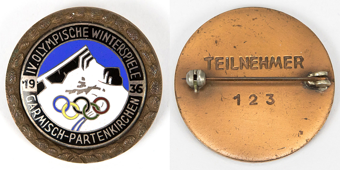 Teilnehmerabzeichen 1936  | Olympische Winterspiele Garmisch-Partenkirchen 1936. Teilnehmerabzeichen für Athleten. Bronze. Mehrfarbig emailliert, Rückseite mit Gravur „Teilnehmer 123“. 3,3 cm.