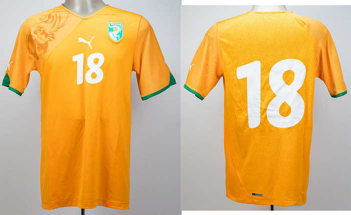  - Original match-worn/issued Ivory Coast player shirt with squad number 18. Worn by Cissé on November 18, 2009, in the friendly match against Germany (2–2). Status: AAB. --Short-sleeved jersey with long inner sleeves (which were cut off). The jerseys originally featured long inner sleeves; while some players wore them as intended, others—including Cissé—cut off the inner sleeves. Rubberized Puma logo and back number; Puma. --The consignor obtained this jersey directly from a former DFB team staff member. Condition: A-