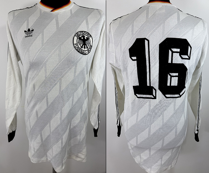  - Original match worn / issued DFB player shirt (number 16, Olaf Thon), prepared for an international match during the 1986/87 season. Status: ABB. Long-sleeved shirt; size 7/8 (L); sewn-on DFB eagle crest; heat-applied manufacturer logo; back number applied using the wet-flock process; 41% cotton, 49% polyester; made in West Germany. --The jersey comes from the collection of a former DFB official. Condition: A