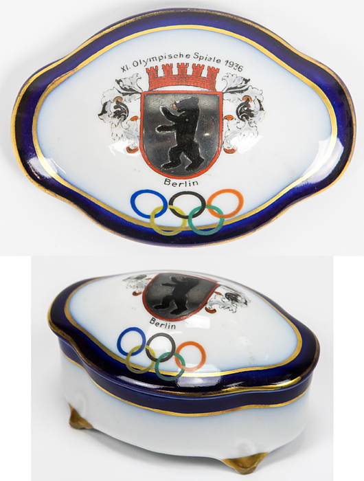 Olympic Games 1936. Commemorative Porcelain box - Porcelain box with lid. Lid with colored Olympic rings and the inscription "XI. Olympic Games 1936 Berlin" and the Berlin city coat of arms. Manufacturer: "BL". 10.5 x 7.5 x 6 cm --Pretty, decorative olympic souvenir Condition: A