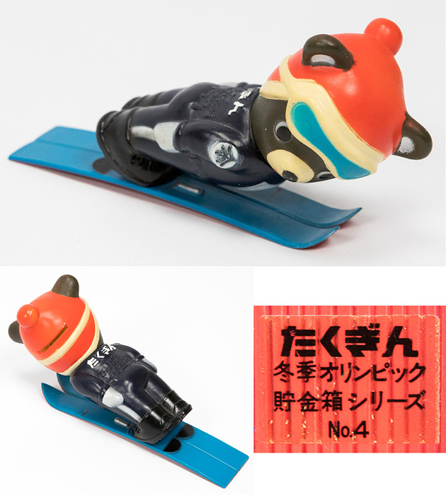 Maskottchen 1972  | Maskottchen für die Olympischen Winterspiele Sapporo 1972. Bär (Skispringer) als Kunststoffspardose. Höhe: 14x3x10,5 cm.