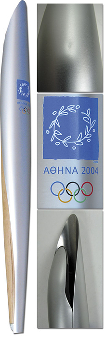 Olympic Games 2004. Official Torch - from the 28th Olympic Summer Games in Athen. Silver plated, light metal and olive wood with colored printing. 68 cm, high the torch resembles an olive leaf and is designed to represent the Greek motto „Pan Metron Ariston“ (all things in moderation). Very nice copy Condition: A