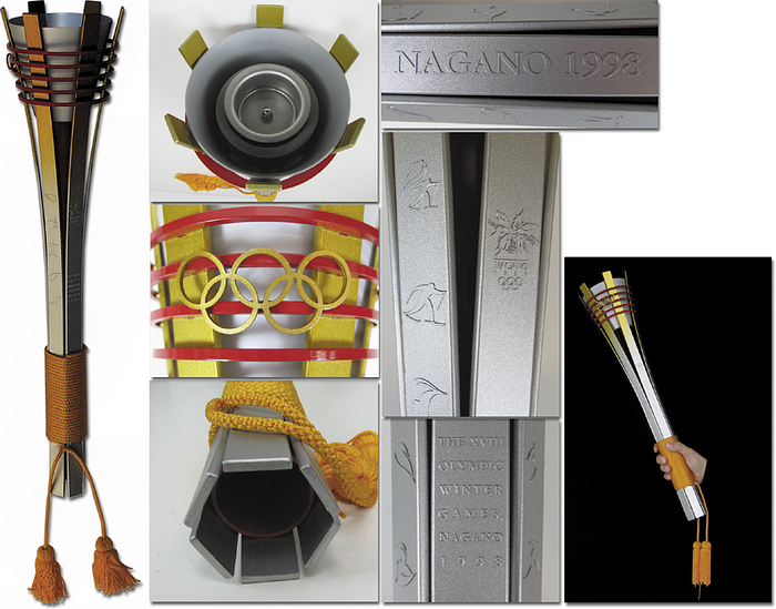 Olympic Games Nagano 1998. Official Torch - Official Olympic Torch from Nagano, 18th Olympic Winter Games. Aluminium, partially gold plated, 55 cm long. Designed as the ancient Japanese torches  „Taimatsu“ were. It shows the Nagano Emblem and Sporting  pictogramms. A brightly colored cord wrapped around the lower part forms the grip with yellow cord and tassles. The torch relay in Japan took part from January 6 until February 7. Rare and beautiful torch as new! Unused Condition: A