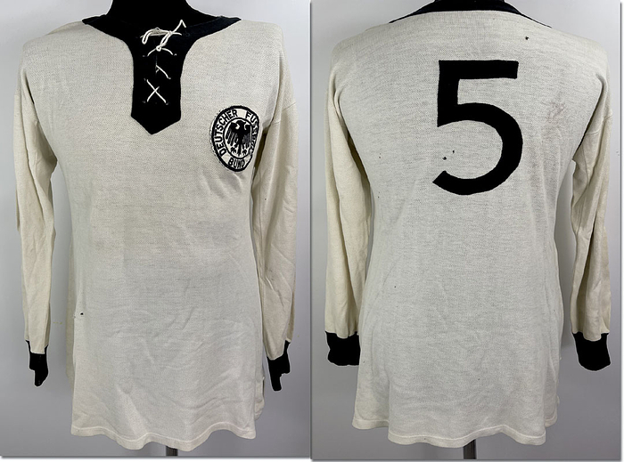 Original match-worn DFB player shirt with the number 5. Worn by Heinz Wewers during an international match in 1958. Wewers made twelve international appearances for the German national team between 1952 and 1958 and was part of the DFB squad during the 1958 World Cup in Sweden, where he played in the third-place match against Sweden.
Longsleeve shirt; size 6; sewn-on DFB eagle; sewn-on Leuzela laundry logo; sewn-on back number; original lacing still in place; 100% cotton; status:ABA.   --The consignor received this shirt directly from the estate of Heinz Wewers. Condition: B