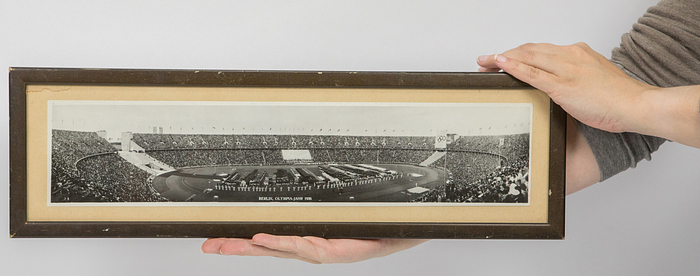  - Olympic Games Berlin 1936: Original black and white panoramic photo from the opening ceremony in Berlin in 1936. "Berlin, Olympic Year 1936" by the company "Copia - Berlin", 41.5x10 cm --Absolutely rare photo. With print on the back "Opening ceremony of the Olympic Games on 1.8.1936" (trilingual) --Photo in very good condition (A-); frame with small chips and cardboard with small damp edge (B) Condition: 