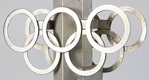 Olympic Games Innsbruck 1976. Official Torch - Original torch from the Olympic relay from Olympia to Innsbruck 1976. Stainless steel and aluminium, manufactured by United Metalworks, Ranshofen-Berndorf AG. Length 74 cm, plate diameter 21 cm. This torch is very rare and one of  less than 100 copies.  --This torch was used in the torch relay for the 1976 Winter Olympics in Vorarlberg. The torch comes from the estate of a high-ranking administrative official from Vorarlberg who worked for sports in this Austrian province from 1967 to 1984. He received this torch as a gift from the manufacturer after the torch relay. The torch has two special features: 1) A plaque bearing the inscription "Ein Geschenk der Vereinigte Metallwerke Ranshofen-Berndorf A.G." was affixed to the handle of the torch by the manufacturer. 2) The manufacturer sealed the torch tip with a screw-on capsule to prevent dirt from accumulating inside the torch. The torch's outlet nozzle was attached to this metal capsule. ---The torch has light speckles of corrosion. Condition: A- - Bild 3