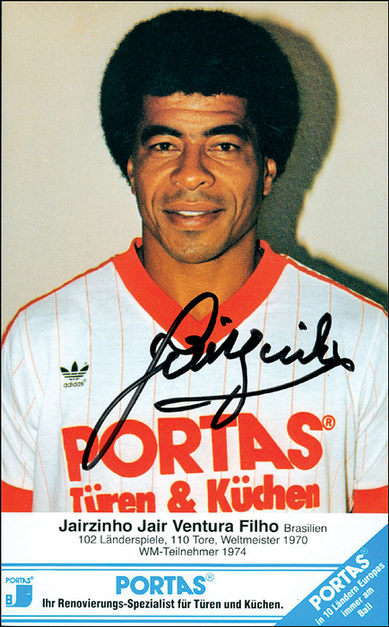 Jairzinho  | Farbautogrammkarte mit original Signatur von Jairzinho (82 LS von 1964-82) mit schöner Widmung "Champion 1970 Mexico". Brasilianischer Fussball-Weltmeister 1970 und WM-Teilnehmer 1966 + 1974. 15.5x10 cm.