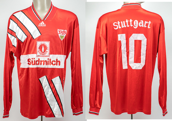  - Original match-worn VfB Stuttgart player shirt with the number 10. Worn in matches of the 1993/1994 Bundesliga season. Sponsor: Südmilch. Status: ACA. --Long-sleeved jersey; size approximately 7/8 (label heavily faded). Embroidered club emblem sewn on; back number and club name thinly flocked; sponsor logo flocked. Adidas logo thinly foiled; manufacturer: Adidas Equipment. The jersey comes directly from the collection of a former high-ranking VfB Stuttgart official, who received this jersey directly from a player in the 1993/94 season. Condition: A-
