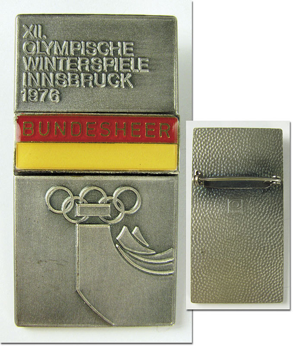 Participation badge: Olympic Winter Games 1976. - Official Badge for the „Bundesheer“ (Austrian Army). Stainless steel with red and yellow enamel, size 5.8x3 cm. Throught the thick cloth. Extremely rare with leather clip. Condition: A