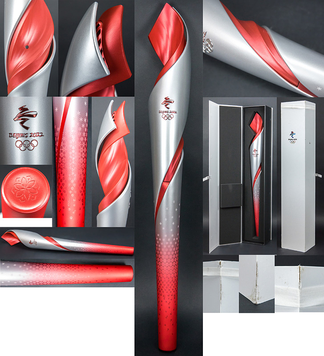 Olympic Winter Games Bejing 2022 Olympic Torch - Original Olympic torch "Flying" fromt the Olympic Winter Games in Beijing 2022 with mounted Olympic Games emblem and inscription  "Beijing 2022". Designed by "Lenovo Team". Aluminium, 82 cm. In original presentation box (88x16.2x16.2 cm). The colours red and silver stand for fire and ice, the red line symbolises the Great Wall. Due to the Corona Pandemic there was only a three day torch relay with 1.200 runners in Beijing, Zhangjiakou and Hebei Province. This torch is hard to get outside of China. Torch as good as new (Condition: A). Comes with original stand for the torch Condition: A