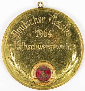 Meistergürtel DDR Boxen 1964  | Original Gürtelschnalle für Bernd Anders (TSC Berlin) den DDR Meister im Boxen mit der Aufschrift "Deutscher Meister 1964 Halbschwergewicht". Messing, mit geröteten Linien und aufgesetztem farbig emaillierten DDR-Staatswappen, 15x11 cm. Dabei die dazugehörige Siegermedaille für den DDR Meister 1964 des Deutschen Boxverbandes mit rückseitiger Gravur "Deutscher Meister 1964 Halbschwergewicht". Bronze, vergoldet mit aufgesetztem emaillierten Staatswappen, 6 cm. - Bild 3