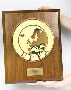  - Large official participant plaque for the German Football Association (DFB) commemorating their participation in the final tournament of UEFA EURO 1972 in Belgium. Each participating national association received one of these plaques. The plaque is made of oak with a large UEFA logo screwed onto it. It features a gilded brass plaque, manufactured by "Huguenin" (21 cm), and a mounted engraved brass plaque (8 x 3.5 cm) inscribed "UEFA to the DFB Final Tournament of the 1972 European Football Championship in Belgium". The overall dimensions are 35 x 28.5 cm. A unique piece. A museum piece! --Germany won the 1972 European Football Championship. A total of four of these commemorative plaques were issued to the participating associations. These solid plaques are designed for wall mounting. Never before offered for sale.  ----The plaque comes directly from the holdings of a private football museum and has already been exhibited in various public exhibitions. Condition: A- - Bild 2