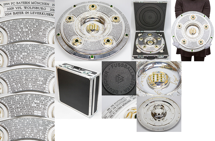 DFB-Meisterschale 2024 Bayer Leverkusen  | Offizielles Replikat der DFB-Meisterschale für die Saison 2023/24 für den deutschen Meister 2024 Bayer Leverkusen. Der jeweilige deutsche Meister hat das Recht Replikas in dieser Größe offiziell anfertigen zulassen.  Letzte Inschrift auf der Schale "Bayer Leverkusen 2024". Versilbert, Messing, ziervergoldet, Gravuren. Hersteller: Koch & Bergfeld, Bremen. Gewicht: 6,6 kg, Durchmesser 52 cm. Mit original Koffer, innen mit geprägtem DFB-Logo. 59x59x18cm. Mit original Signaturen von Xabi Alonso, Florian Wirtz, Jonathan Tah und Robert Andrich. Weil die Spieler von Bayer Leverkusen von ihrem Trainer Xabvi Alsonso anläßlich der Deutschen Fußballmeisterschaft eine kleine Meisterschale (ca. 18 cm) aus Silber bekamen, machte keiner der Spieler von seinem Recht  gebrauch sich von der Firma Koch & Bergfeld eine fast 1:1 Kopie der orignal Meisterschale anfertigen zu lassen. Es wurden laut Aussagen des Einlieferes lediglich zwei Exemplare produziert. Ein Exemplar befindet sich im Museum / Klubräumen von Bayer Leverkusen in der BayArena. Das andere Exemplar wird in dieser Auktion angeboten. Mit original Plexiglasständer für diese Meisterschale. EIN HIGHLIGHT FÜR JEDE SAMMLUNG!.