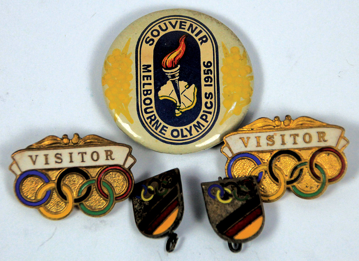  - Five badges from the 1956 Melbourne Olympic Games, including two badges from the unified German team. Sizes range from 3.3 cm to 1.4 x 1.1 cm. --The badges were personally collected in Melbourne by German national football player Rudi Hoffmann (1935-2020; 1 international cap) and participant in the Olympic football tournament for Germany at the 1956 Melbourne Olympic Games. Badges directly from Hoffmann's estate. Condition: A-