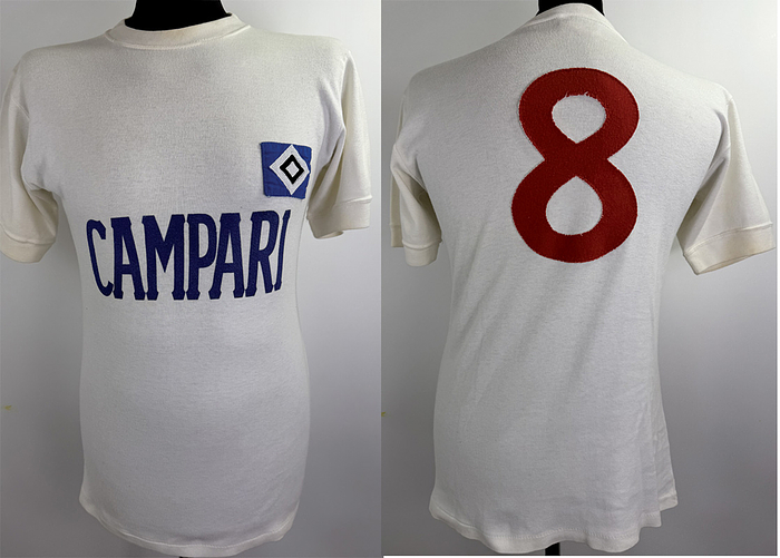match worn football shirt hsv 1974 - Original match-worn HSV player shirt with the number 8. Worn in a Bundesliga match during the 1974/1975 season. The jersey was exhibited in the Hamburger Sport-Verein museum and is also mentioned in the HSV shirt book. Status: AAB short-sleeved jersey; size M; HSV logo sewn on; sponsor "Campari" embedded in the jersey; back number sewn on in linen; manufacturer: Umbro; 100% cotton; made in England. Condition: A
