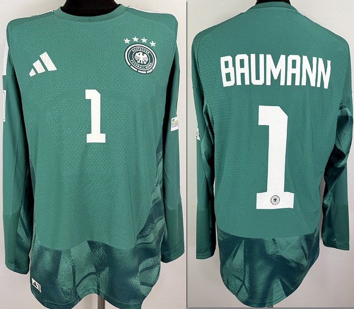  - Original match-issued DFB player shirt with the number 1, worn by Oliver Baumann. Prepared for the 2026 World Cup qualifier against Slovakia on November 17, 2026, in Leipzig. The jersey comes from the collection of a former DFB employee. Status: AAB. Long-sleeved shirt; size 8; DFB logo, rubberized Adidas logo, rubberized player number and name; rubberized 2026 World Cup qualifier patch; flocked Hearts and Foundation patches; Adidas Climacool+; 100% polyester; made in Vietnam. Condition: A