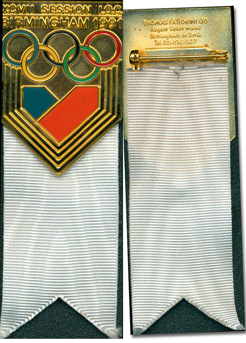  - Official participant badge of the "XCVII Session IOC Birmingham 1991". Gilt bronze, colored enamel, white silk ribbon. Engraved with the name of Walter Tröger (1929-2020; former IOC member and current honorary member). 9.5 x 3.3 cm, in original box (plastic, 11.5 x 5.5 cm). --Directly from the collection of Walter Tröger Condition: A