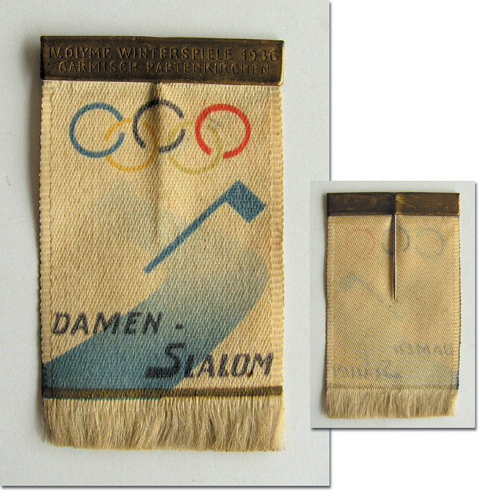 Olympic Games 1936. Entrance Badge: Skiing - Silk badge with needle and m/c printing for the Ladies Slalom in Garmisch-Patenkirchen with metal band enscribed  „IV.Olymp. Winterspiele 1936. Garmisch-Partenkirchen“. Size 6x3.4cm. Very rare! Condition: A-