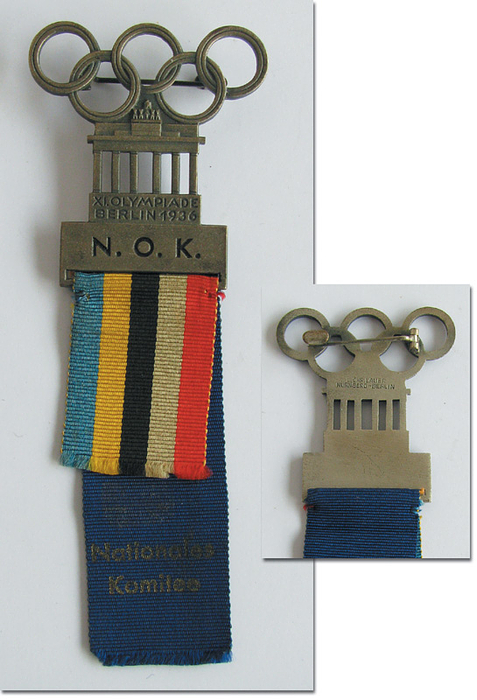  - Olympic Games Berlin 1936 Participation badge „N.O.K.“ (National Olympic Committee). Bonze, gilt. With short ribbon in Olympic colours and long blue ribbon inscribed „Nationales Komitee“, 11x4.1 cm. -- Printed inscription on blue silk ribbon slightly faded, otherwise beautiful (EF) Condition: A-