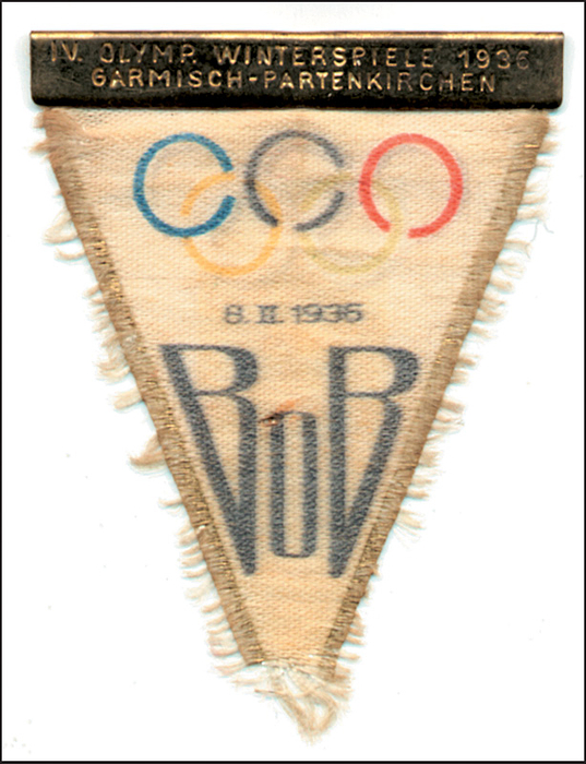 - Olympic Winter Games 1936. Admittance badge  for visitor's to the Bob slieghing on 8th Febuary. Silk, multicoloured print with embossed brass plate „IV.Olymp. Winterspiele 1936. Garmisch-Partenkirchen“.  Extremely rare badge, unfortunately the needle for fixing the badge is missing otherwise a beautiful piece, size 6x3.4cm. VF. Condition: B
