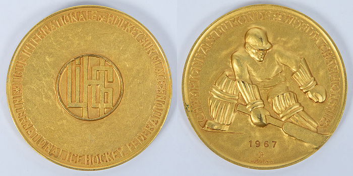  - Gold medal from the 1967 Ice Hockey World Championships with the inscription "Championnat du Monde. World Championship" and the engraving "1967." Awarded to the USSR players for the world championship title. Manufacturer: "Hugenin." Bronze, gold-plated, 6 cm --Approximately 35 medals were issued. Excellent (EF). -- From the collection of a former Swiss ice hockey club president, who collected these medals between approximately 1964 and 1980. Condition: A