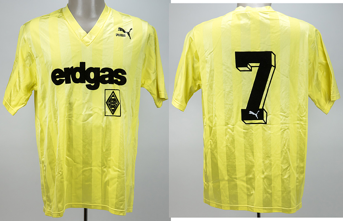  - Original match-issued Borussia Mönchengladbach player shirt with number 7. Designed for a single match in the 1987/1988 season. Short-sleeved shirt; size M; club emblem, chest sponsor, and player number flocked using a wet flocking process; manufacturer logo "Puma" rubberized; 70% polyamide, 30% triacetate; Made in West-Germany Status ABA --The jersey comes from the collection of a former employee of Borussia Mönchengladbach Condition: A-