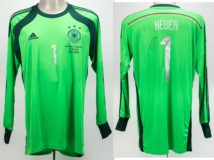  - Original adidas fan shirt from the 2014 FIFA World Cup, featuring the squad number "1" for legendary goalkeeper Manuel Neuer, complete with the match print from the final—"Germany v Argentina, July 13, 2014, Rio de Janeiro"—and an authentic autograph by Manuel Neuer on the back, positioned next to the number. Neuer wore a green jersey in this very design during the final match! --adidas Climacool. Size "L". The match print was applied retrospectively and is not an original DFB print. —Minor stains. Condition: A-