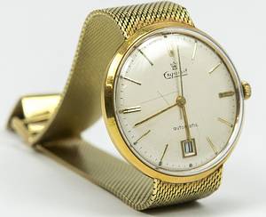 1Dortmund,Borussia-Goldene Uhr 1966  | Stan Libuda wurde 1966 mit Borussia Dortmund Europapokalsieger. Aus diesem Anlass schenkte Borussia Dortmund allen beteiligen Spieler eine goldene Uhr der Marke "Exquisit Automatic" mit Sekundenzeiger und Datumsanzeige. Auf der Rückseite wurde ein Erinnerungschriftzug eingraviert "BVB 09 Europa Pokalsieger 1966". Das Gehäuse ist aus Gold 18 k - 0,750 (gepunzt). Das Milanesearmband ist ebenfals aus Gold 14 k - 585 (gepunzt). Das Gesamtgewicht der Uhr beträgt 65 Gramm (das Uhrwerk ist nicht aus Gold). Persönliche Armbanduhr von Stan Libuda, der diese Uhr auch häufig getragen hat! Museumstück! - Bild 3