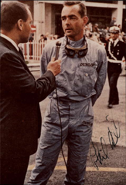 Hill, Phil  | (1927-2008) Originalsignatur auf Farbrepro vom Formel 1-Fahrer Phil Hill (48 Grand Prix) und Weltmeister 1961. 14,5x10,5 cm.