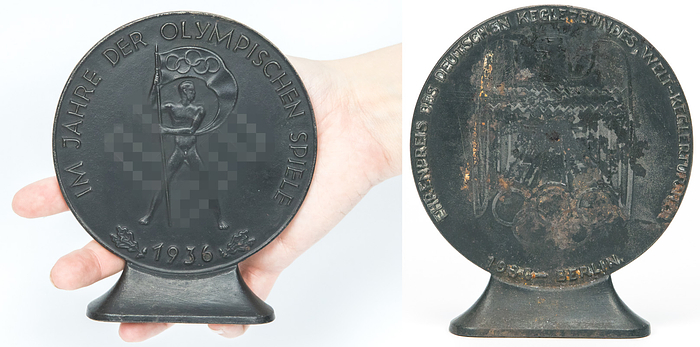  - Olympic Games Berlin 1936: Large cast iron medal inscribed "Im Jahr der Olympischen Spielen 1936" (in the year of the Olympic Games). 11.7 cm on a iron base. An absolutely rare medal of 1936. The standard version of this medal shows the year "1935". With special inscription "Honorary Award of the German Bowling Association - German Championships 1936" (usually the medal was issued without this inscription) ---Image side with special inscription with minor rust spots Condition: B-