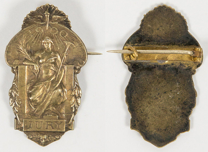  - Olympic Games 1900. Judge´s badge: Participant badge for the 1900 Paris Olympic Games, "Jury" (referee). Manufacturer: Christofle, Paris. Bronze, silver-plated, 4.1 x 2.3 cm. --Buttonhole closure is missing and has been replaced by a pin Condition: A-