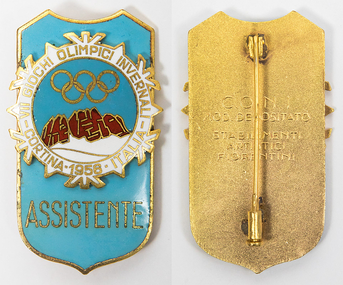 Olympic Winter Games 1956. Participation badge - Official participation badge 1956. Olympic Winter Games Cortina d'Ampezzo 1956. With inscription "Assistente". Bronze, gold plated, multicolour enamelled, 5.3x3.2 cm. With original paper bag. Small faults due to production. This is one of the rares badges of the Olympic Games 1956, only 70 copies were produced (Ebel 2016, 1956-W-016). Condition: A-