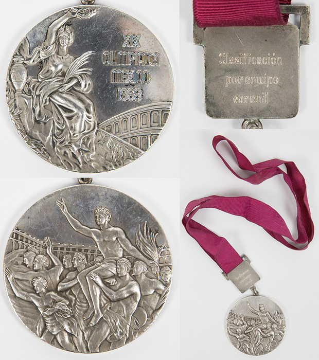  - Official silver medal for the USSR men's team gymnastics for second place in the pommel horse at the 1968 Summer Olympics in Mexico. Silver (124 grams), 6 cm, with a silver plaque bearing the gymnastics symbol. Engraved on the reverse of the plaque is "Classification par equipe varonil" (Men's Team Classification). With original burgundy silk ribbon. --The consignor received this medal directly from a USSR athlete in the 1990s. Condition: A