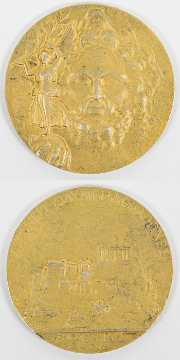  - Olympic Games Athen 1906.  Gold Winner Medal: Gold winner's medal for first place at the 1906 Athens Olympic Games with Greek inscription. Engraved with "Argent" (silver) on the edge. Silver (59 grams), gold-plated. 5 cm. --very slight gold abrasion on the raised areas of the medal Condition: A-