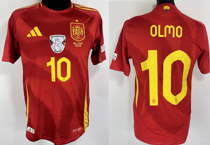  - Original match-issued Spain player jersey with the number 10 worn by Dani Olmo, prepared for the European Championship match against Germany on July 5, 2024. Status: AAB Short-sleeved jersey; size M; club emblem, Adidas manufacturer logo applied; player number and name rubberized; rubberized match print, European Champions patch flocked; Foundation patch flocked; 100% polyester; Made in Cambodia.Status AAB --It comes from the collection of a DFB employee. Condition: A