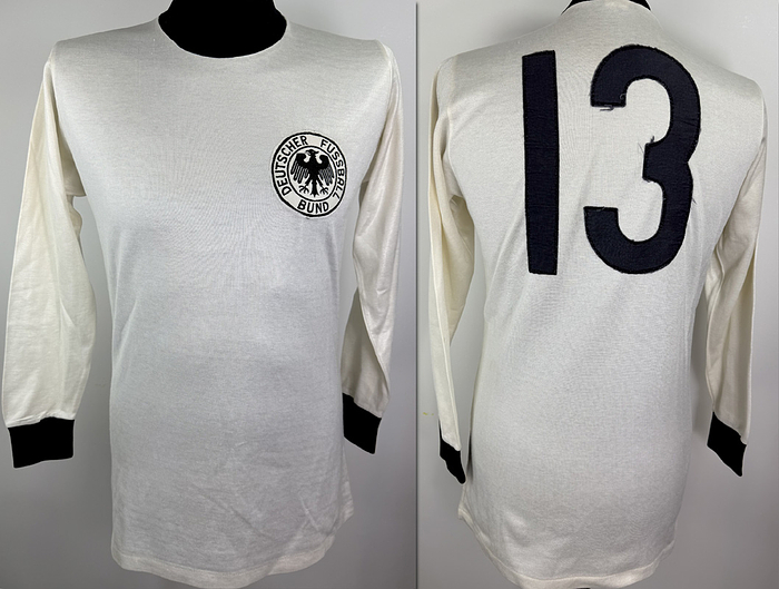  - Original match-worn Germany player shirt with the number 13. Worn by Dietmar Danner in a match during the 1976 European Championship in Yugoslavia. The shirt comes from the collection of a former DFB (German Football Association) staff member. Status ABA jersey, long-sleeved; size M; DFB crest embroidered; player number sewn on; polyester-cotton blend; made in West Germany. Condition: A