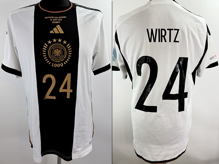  - Original match issued DFB jersey with the number 24, worn by Florian Wirtz. Prepared for the international match against Ukraine on June 12, 2021, in Bremen. The DFB eagle on the jersey features a design created especially for the 1000th international match of the German national team. Condition: AAC; short-sleeved jersey; size L; DFB eagle and Adidas logo embroidered; player number and name rubberized, "We are here for you" patch and peace patch rubberized; 100% polyester; made in China; condition A. Condition: A