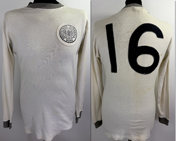  - Original match-worn DFB (German Football Association) player shirt with the number 16 from the 1968/1969 international season. Long-sleeved, manufactured by Umbro. From the collection of Willi Schulz. Status: ABA (Additional Markings). Long-sleeved shirt; size M; DFB logo sewn on, linen number sewn on the back; minor signs of storage; jersey shows signs of wear; 100% cotton; Made in England; The jersey comes from the collection of German international Wili Schulz. Condition: B