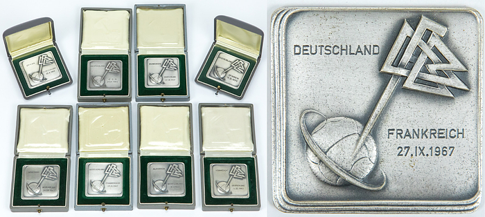  - 8 DFB Honorary Plaques awarded to Reinhard "Stan" Libuda for his participation in DFB senior international matches; each features an engraving and date, measuring 4.7 x 4.7 cm. Silver-plated bronze, presented in their original cases. Libuda earned 26 international caps between 1963 and 1971. The collection includes plaques commemorating the following matches: 1964 vs. Morocco and Sweden; 1964 vs. Algeria and Czechoslovakia; 1967 vs. France and Romania; 1969 vs. Cyprus; and 1970 vs. Spain.  This item comes directly from the estate of Reinhard "Stan" Libuda (1943–1996). 3rd Place – 1970 FIFA World Cup. 26 Senior International Caps (DFB). 289 Bundesliga Matches (Schalke 04 + Borussia Dortmund). European Cup Winner 1966 (with Dortmund). DFB Cup Winner 1972 (with Schalke). German Vice-Champion 1966 (BVB) + 1972 (Schalke). The item is supplied with a Certificate of Authenticity (COA)! Condition: A-