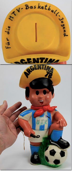  - World Cup 1978. Official mascot Gauchito as saving bank. Large coloured plastic figure with turnable head. Figures of this size are very rare. Size 30x17x10 cm. --with signs of usage and handwritten notes on the hat and the shirt Condition: B