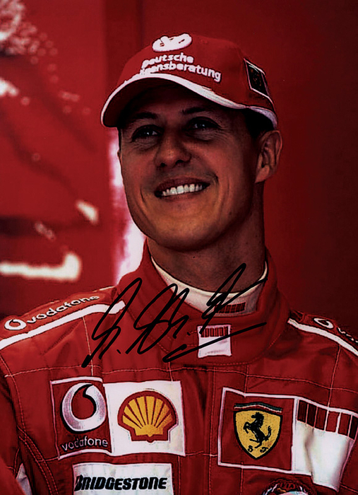 Schumacher, Michael  | Farbdruck Portrait Michael Schumacher im Ferrari Rennanzug mit Originalsignatur mit Filzstift des 7-fachen Formel 1-Weltmeisters Michael Schumacher. 28x20cm. Mit Echtheitszertifikat von "Tamper Seal".