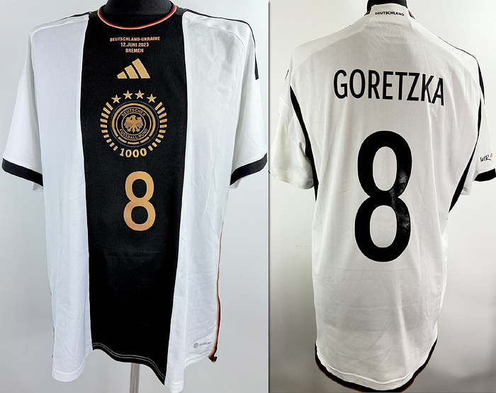  - Original DFB jersey with the number 8, worn by Leon Goretzka. Prepared for the international match against Ukraine on June 12, 2021, in Bremen. The DFB eagle on the jersey features a design created especially for the 1000th international match of the German national team. Condition: AAC; short-sleeved jersey; size XL; DFB eagle and Adidas logo embroidered; player number and name rubberized; "We are here for you" patch and peace patch rubberized; 100% polyester; made in China; condition A. Condition: A